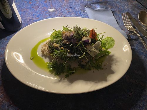 Portobello mushrooms stuffed with breadcrumbs and parsley accompanied by savoury porridge made from oats and hazelnut at Meteo Restaurant & Beach Bar in Merano