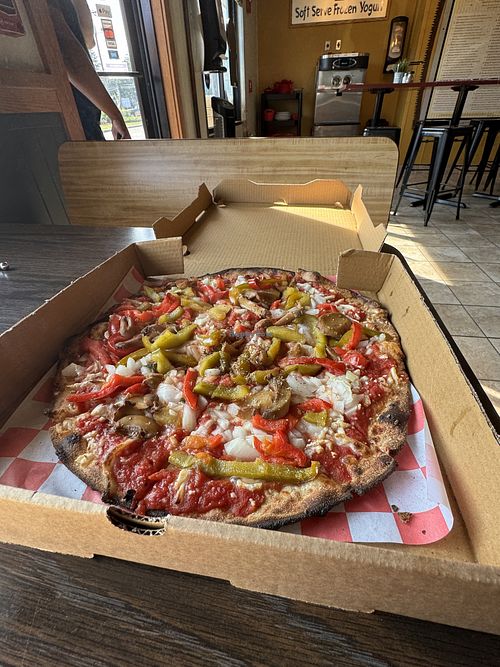 Onions, peppers, with mushrooms with the vegan cheese.  at Kindles Wood Fired Pizzeria in Marlborough
