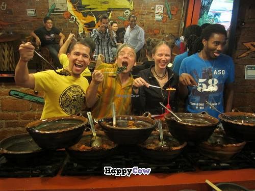 The owner, Gustavo Millán, (left) drags gringo customers behind the serving line for a photo op with staff. at Tacos Gus in Mexico City