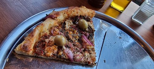 The last two slices of pizza. I was hungry, so I forgot to take the picture before we tucked into it! at Laborum Pizzaria in El Chalten