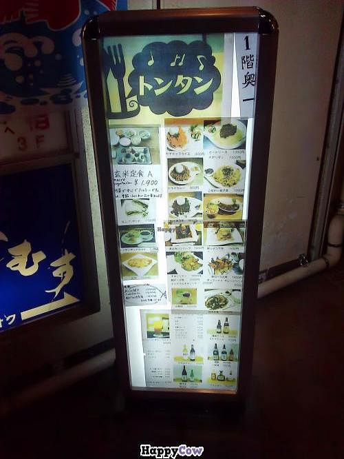 The sign outside the restaurant where you can see the logo and the menu in Japanese. There is an English menu inside the restaurant and the staff speaks English.  at Tomtam in Kamakura