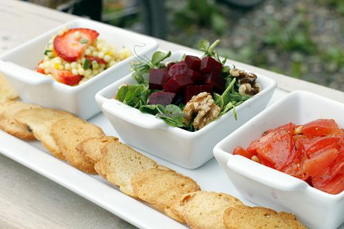 Three salads: Israeli couscous with strawberries, beets with greens and walnuts, and tomatoes with pinenuts.  Served with toasted baguette drizzled in olive oil. at Eddyline Bistro Cafe in Smithers