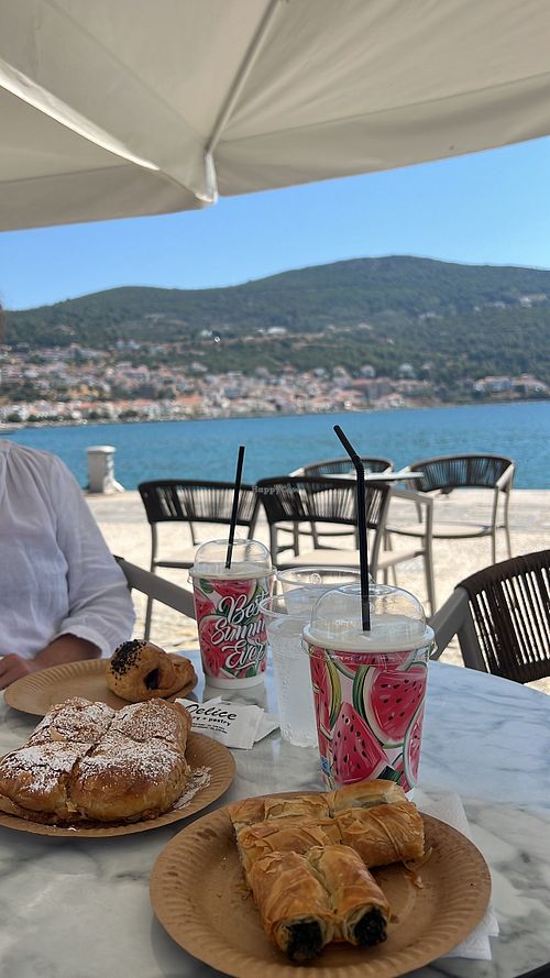 The vegan spinach roll and a lovely view🩷  at Delice Bakery & Pastry in Samos
