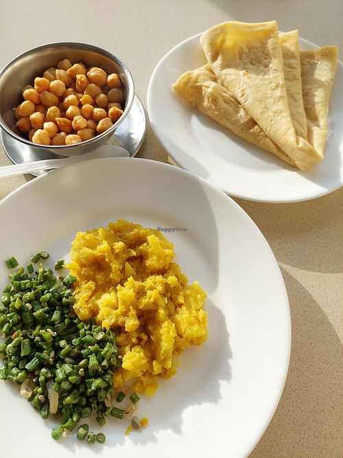 Roti with potatoes and greens (125 SRD). Channa (50 SRD). at Roti Shop Joosje in Paramaribo