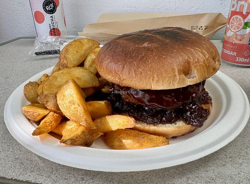Vegan burger (meat-like)  with fried potato wedges  at Mentor Coffee Guidance & More in Milos