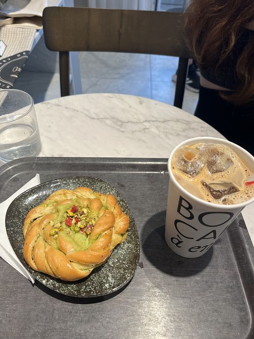 Pistachio bun and iced oat latte   at Gateau Vaxholm in Vaxholm