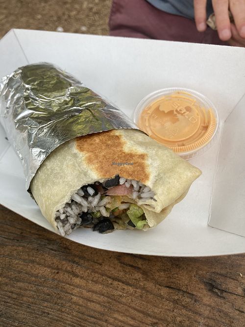 Burrito with volcano tempeh (vegan sauces are chimichurri - very garlicky but good - and sriracha aioli   at Muñecas Taco Garden and Bar in Gainesville