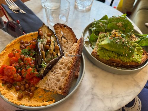 Aubergine and humous plate with crunchy chickpeas and avocado and pea purée toast. at Maison Fleuret in Paris