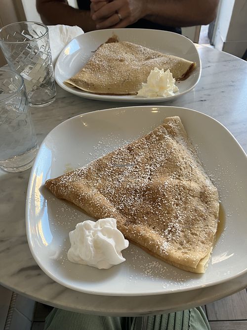 Plant-based lemon sugar crepe in front, vegetarian tiramisu crepe in back.   at Canela Crepes & Coffee in Toronto