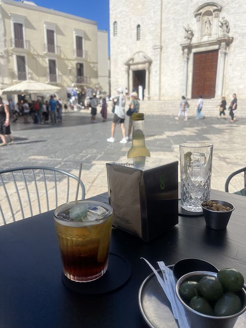 Olives, cocktail and ‘fried beans’ (broad beans snack).  at Caffè del Borgo in Bari
