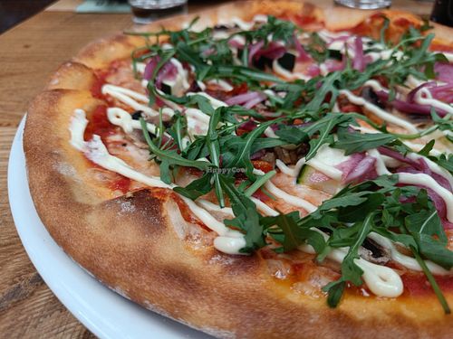 Pizza with rucola on top. at Rosso in Tampere