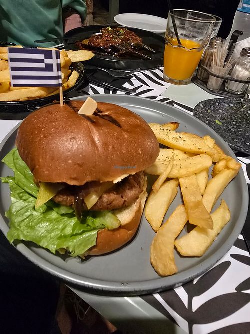Vegan burger, side of chips, and Imam aubergine at Kalomirakis Tavern in Crete