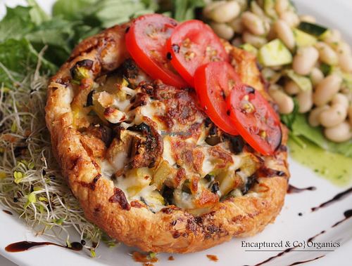 Summer Veggie Tart with Sprout's own freshly picked Garden Veggies and Fresh Herbs grilled and baked in Tender & Flaky Puff Pastry...Topped with Feta and Mozzarella Cheeses, Fresh Garden Tomatoes & Balsamic Drizzle! at Sprouts Cafe in Gastonia