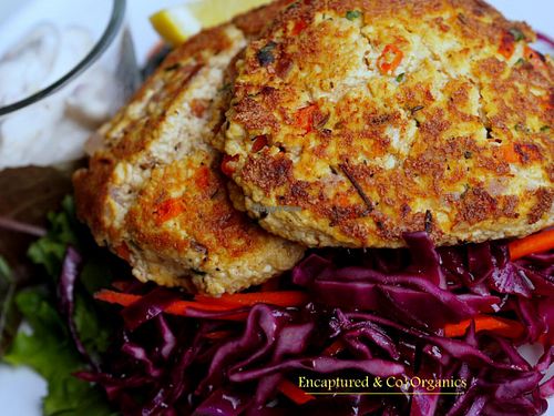 Vegan Crab Cakes! Organic, Non-gmo tofu, hand pressed, crumbled, and mixed with onion, garlic, carrots, spices and herbs, grilled and served with a dill tarter sauce on a bed of red cabbage salad.  at Sprouts Cafe in Gastonia