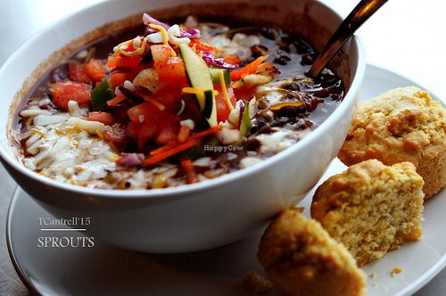 Black Bean Chili topped with Fresh Veggie Pico de Gallo, Cheddar, Pepper jack, and Mozzarella Cheeses served with 2 warm, Gluten Free Corn Muffins!  at Sprouts Cafe in Gastonia