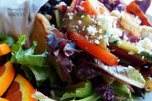 Grilled Veggie Pita in a Warm, Toasty, Pita filled with seasonal grilled veggies, Marinated tomato, Cucumber, Mixed Greens, Feta Cheese and a thin spread of Garlic Hummus!  at Sprouts Cafe in Gastonia