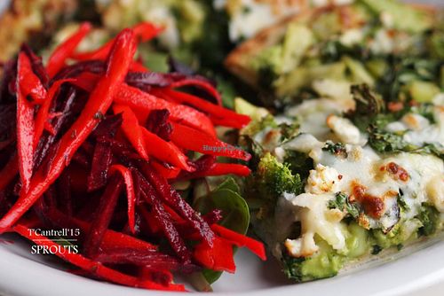 Green Veggie Pizza! Our Organic, Marinated Green Veggies including: Kale, Zucchini, Celery, Broccoli, Brussels Sprouts, and Bell Peppers on a Traditional Crust with Creamy Tangy Avocado Base and 3-cheese blend!  at Sprouts Cafe in Gastonia