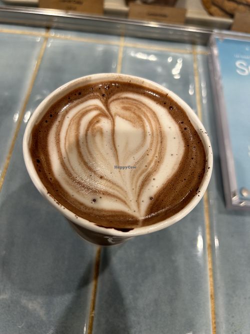 Latte with oat milk   at Syra Coffee in San Sebastian