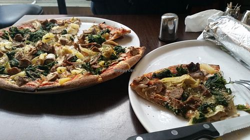Vegan kebab pizza in a whole wheat base with vegan cheese, pineapple, onions, spinach, artichoke and mushrooms. The sliver wrap is a vegan durüm/wrap whole wheat vegan ham lettuce tomatoes pepper and cucumber. at Express Pizza in Copenhagen