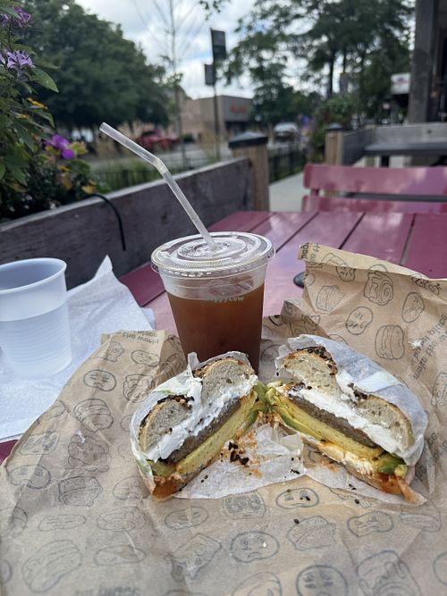 The breakfast sandwich and a iced coffee on the patio   at R&A Sourdough in Chicago