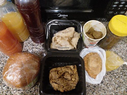 Things I bought. Total cost was less than $20 USD. 3 juices, 1 burger (pattie made by them from chickpeas, split peas etc), roti with katahar, mango archar in the container with th at Veggie Castle in Reliance