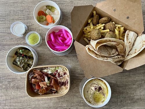Platter inc options of babaganoush & foul. Stuffed vine leaves, hummus, falafel and chips, pickles and extra bread   at Falafel Chef - Kiosk in Liverpool