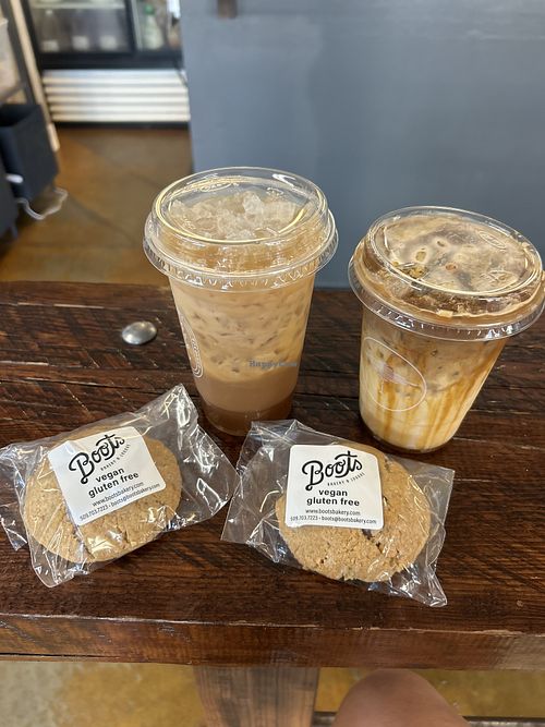 Banana milk caramel iced latte and iced americano with oat milk and two no bake muffin peanut butter chocolate chip.   at Indaba Coffee - W Broadway Ave in Spokane