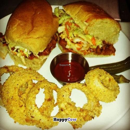 BBQ Sandwich on a Niedlov's wheat hoagie, topped with coleslaw. Served with oven baked onion rings. 100% oil free! at Cashew in Chattanooga