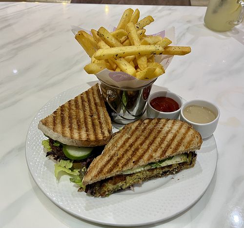 Falafel aubergine sandwich with fries  at Mani's Cafe in Muscat