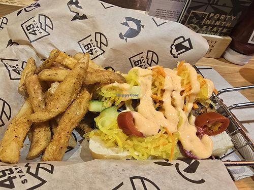 Vegan sausage Bahn mi w brew fries at ANC - 49th State Brewing - Ted Stevens Concourse C in Anchorage