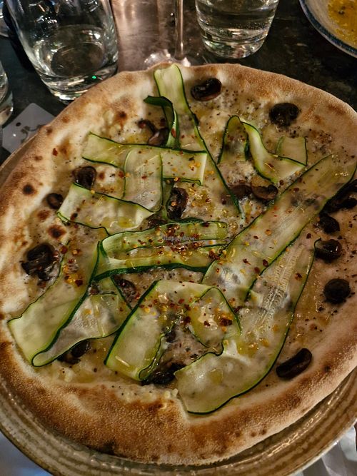 ZUCCHINE E TARTUFO: White base, soy truffle cream, courgette ribbons, vegan mozzarella-style cheese, chestnut mushrooms, chilli & basill at Piccolino in Wilmslow
