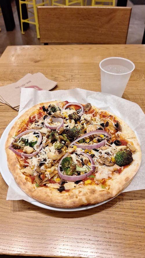 Thick crust pizza with vegan cheese, vegan sausage, and various veggies at Mod Pizza - Midtown in Phoenix