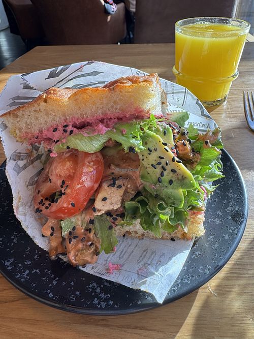 Focaccia filled with beetroot hummus, lettuce, tomato and avocado   at Pella's Cafe & Bakery in Tampere