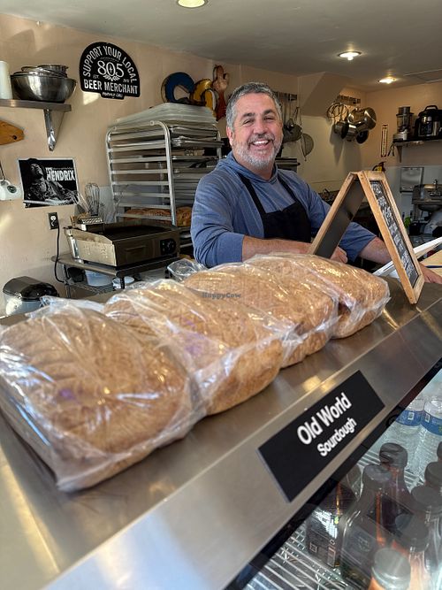 Owner with his daily baked sourdough breadd  at House of the Rising Buns in Pismo Beach