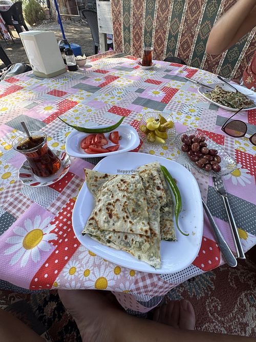 Spinach gözleme with sides of olives, pickles and tomatoes   at Gözde Cafe in Mugla