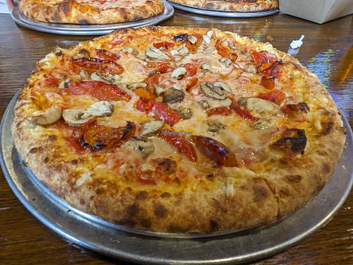 Hand toss crust, vegan cheese, mushrooms and roasted tomatoes. at Fire on Fifth in Peru