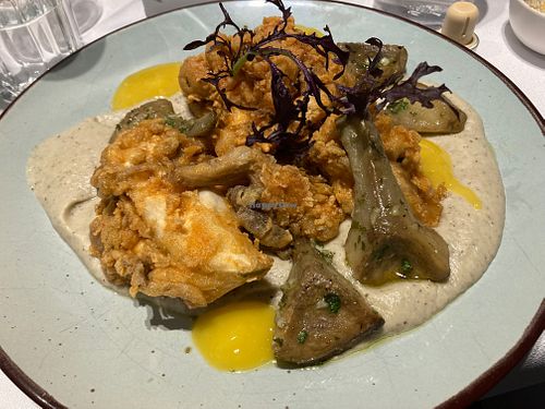 Fried mushrooms on roasted aubergine cream, artichokes and mango cream at Veguria in Santiago