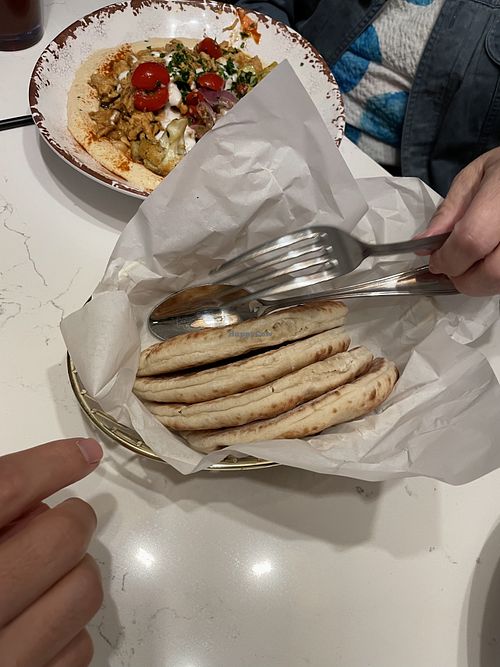 Side of pita bread (top of picture is hummus bowl with chicken (not vegan))  at Meddys in Kansas City