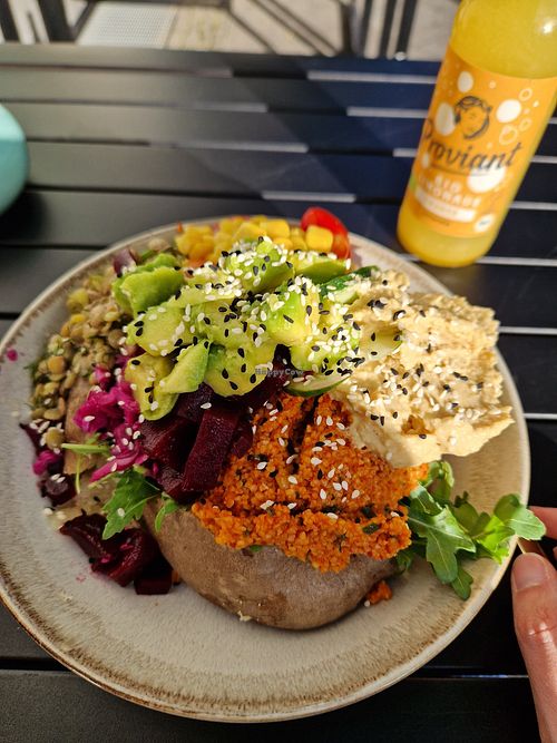 Kumpir vegano, topped with masses of avocado, hummus, and all sorts of salad at Kumpir Club Fresh Food & Coffee in Berlin