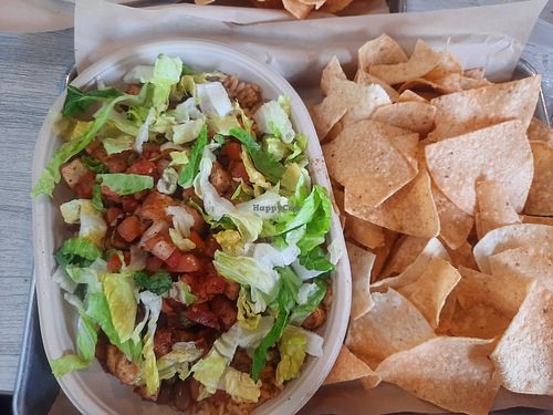 Burrito bowl with brown rice, lettuce, pinto beans, and tofu. Side of tortilla chips at Moe's Southwest Grill in Monroeville
