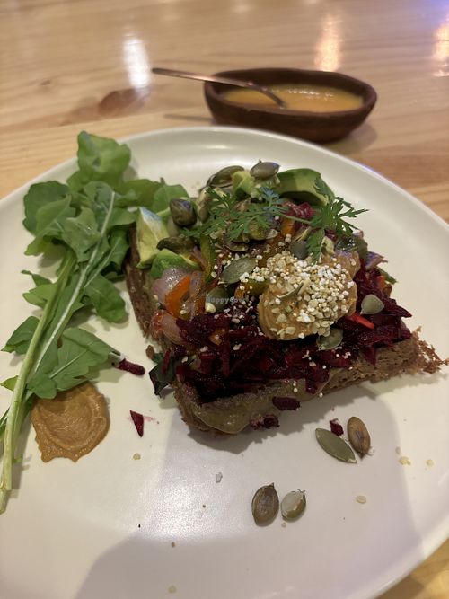 Savory waffle with veggies, seeds, and a delicious spicy sauce   at Kuruba in Cuenca