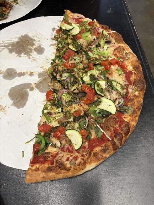 Large Veggie Pizza with vegan cheese (half eaten)!  at Geno D's Pizza - Market at 7th in Charlotte