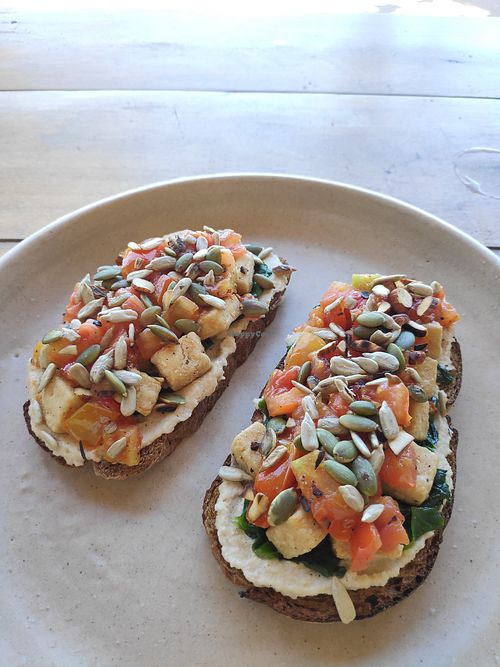 Toast with cashew cream cheese, tofu, tomatoes, spinach and nuts at Meori in Arugam Bay