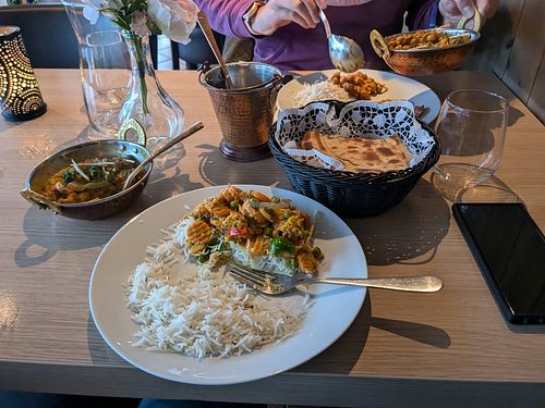 Vegetables jalfrezi with rice and roti in the basket. The white garnish is ginger at Sharma's Indiske Restaurant in Elverum
