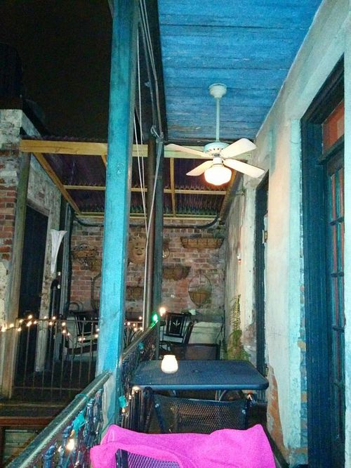 Dining area overlooking a nice courtyard to the side & below at Bhava in New Orleans
