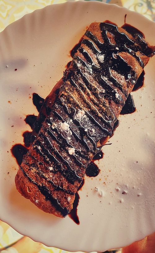 Ragi Pancake with Banana and Chocolate sauce at Prakriti Cafe by Ecolivinghomes in Pushkar