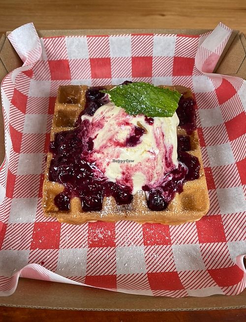 Vegan waffle with warm berry compote and ice cream  at Müllfords Deli in Maleny