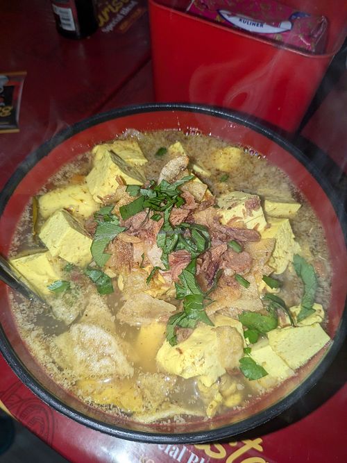 Hot dish with tofu, tempeh, noodles, rice (and potato chips!!) at Warung Riska  in Ngadisari