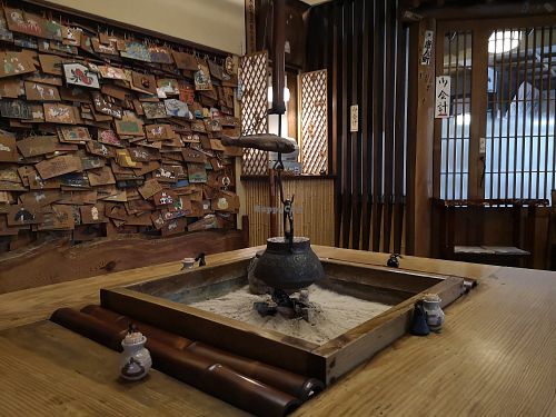 Entryway table woth votives on the wall at Shika-Jaya in Hakone