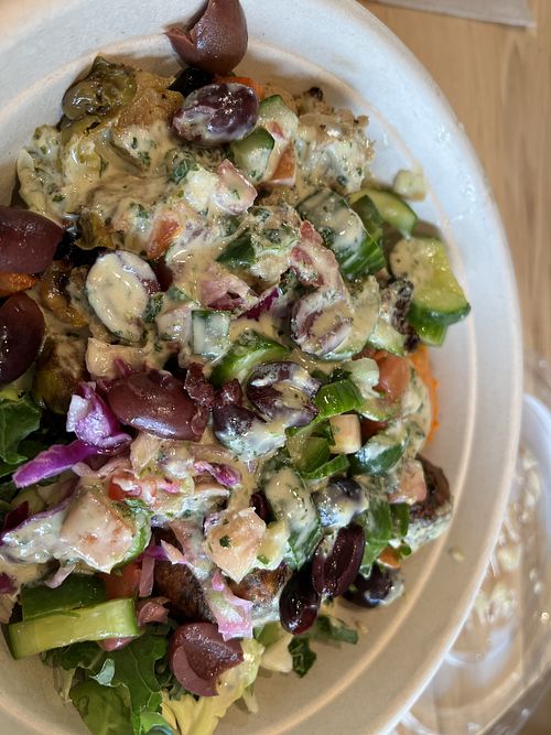  Salad bowl with supergreens, red pepper hummus, falafel, cabbage slaw, cucumbers, tomato/cucumber salad, olives and lemon herb dressing at CAVA in College Station